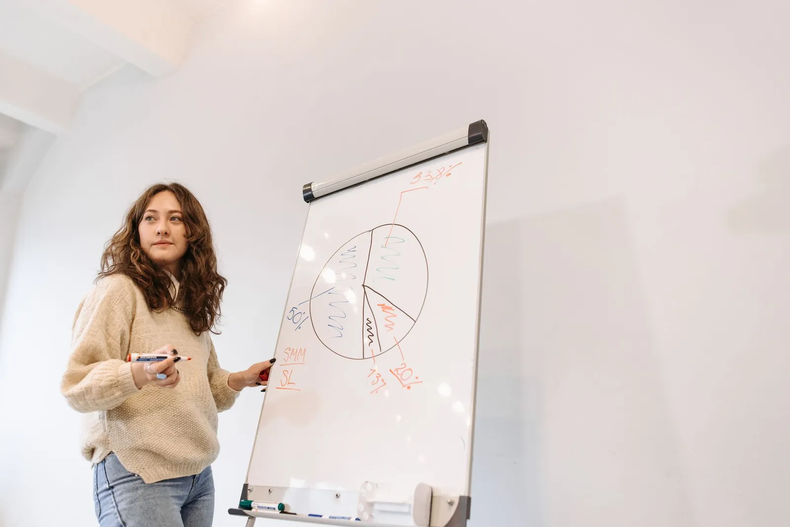 An educator sketching simple diagrams and equations in a bright study space