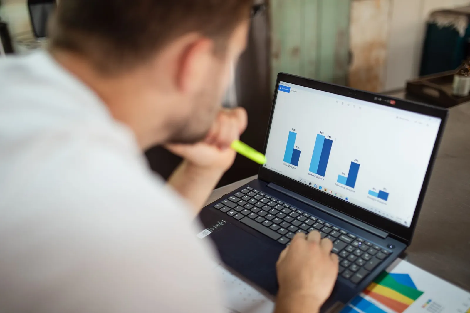 A learner working through worksheets with simple charts and graphs at a bright desk